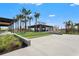 Exterior view of a community center featuring common spaces and lounge seating, surrounded by landscaping at 8328 Sea Glass Ct, Sarasota, FL 34240