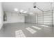 Spacious three car garage featuring epoxy flooring and plenty of room for storage at 8328 Sea Glass Ct, Sarasota, FL 34240