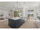 This spacious kitchen island features plenty of room and overlooks the outdoor pool and lake at 8328 Sea Glass Ct, Sarasota, FL 34240