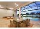 Outdoor dining and seating on the lanai with a beautiful view of the lake and pool at 8328 Sea Glass Ct, Sarasota, FL 34240