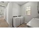 Well-lit laundry room featuring new washer and dryer, bright window and ample counter space at 8328 Sea Glass Ct, Sarasota, FL 34240
