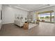 Bright living room featuring a tray ceiling, stylish furnishings, and a seamless transition to the outdoor space at 8328 Sea Glass Ct, Sarasota, FL 34240