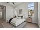 Inviting main bedroom featuring a decorative rug, tray ceiling, fan, and large windows for plenty of natural light at 8328 Sea Glass Ct, Sarasota, FL 34240