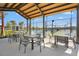 Outdoor lounge seating area with shaded tables overlooking community pickleball courts at 8328 Sea Glass Ct, Sarasota, FL 34240