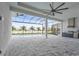 Expansive screened patio with an outdoor kitchen overlooking the pool and scenic water view at 8328 Sea Glass Ct, Sarasota, FL 34240