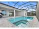 Inviting screened pool and spa with steps, surrounded by a paved deck for leisure and enjoyment at 8328 Sea Glass Ct, Sarasota, FL 34240