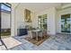 Lanai featuring an outdoor kitchen and dining area with great lighting and modern finishes at 8328 Sea Glass Ct, Sarasota, FL 34240