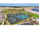 Aerial view of the community tennis and pickleball courts and surrounding landscaping at 8328 Sea Glass Ct, Sarasota, FL 34240