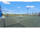 Exterior view of community tennis courts with lights, fencing, and common areas at 8328 Sea Glass Ct, Sarasota, FL 34240