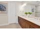 Elegant bathroom with double vanity, large mirror, and plenty of storage at 8752 Bellussi Dr, Sarasota, FL 34238