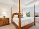 Main bedroom with a four poster bed and ample natural light at 8752 Bellussi Dr, Sarasota, FL 34238