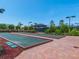 Two bocce ball courts with landscaping and a covered seating area at 8752 Bellussi Dr, Sarasota, FL 34238