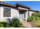 Teal front door entryway with brick walkway and lush landscaping at 8752 Bellussi Dr, Sarasota, FL 34238