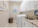 Convenient laundry room with washer, dryer, and extra storage at 8752 Bellussi Dr, Sarasota, FL 34238