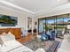 Living room with hardwood floors, white sofas, and view of Primary bedroom at 8752 Bellussi Dr, Sarasota, FL 34238