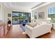 Living room with hardwood floors, white sofa, and access to patio at 8752 Bellussi Dr, Sarasota, FL 34238