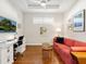 Home office with comfortable seating and a large TV at 8752 Bellussi Dr, Sarasota, FL 34238