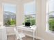Bright home office with white desk and window seat at 8752 Bellussi Dr, Sarasota, FL 34238