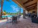 Resort-style pool with patio furniture, umbrellas, and a covered seating area at 8752 Bellussi Dr, Sarasota, FL 34238