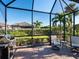 Relaxing screened porch with comfortable seating and grill at 8752 Bellussi Dr, Sarasota, FL 34238