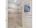 Walk-in shower with glass enclosure, built-in seat, and neutral tile at 8752 Bellussi Dr, Sarasota, FL 34238