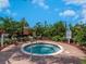 Community hot tub with surrounding landscaping and seating at 8752 Bellussi Dr, Sarasota, FL 34238