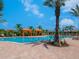 Relaxing community pool with orange umbrellas and lounge chairs at 8752 Bellussi Dr, Sarasota, FL 34238