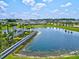 Aerial view of houses and community lake at 9016 Waxwing Way, Parrish, FL 34219
