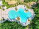 Overhead view of a large community pool with surrounding lush landscape at 9016 Waxwing Way, Parrish, FL 34219
