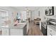 Open concept kitchen with island, hardwood floors, and view to living room at 9016 Waxwing Way, Parrish, FL 34219