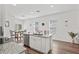 Open kitchen with granite island, stainless steel appliances, and view to backyard at 9016 Waxwing Way, Parrish, FL 34219