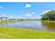 Community lake view with lush green space at 9016 Waxwing Way, Parrish, FL 34219