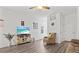 Living room with hardwood floors, comfy seating, and a view of the backyard at 9016 Waxwing Way, Parrish, FL 34219