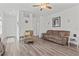 Spacious living room with hardwood floors, comfortable seating, and open floor plan at 9016 Waxwing Way, Parrish, FL 34219