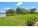 Peaceful pond view from a grassy backyard, serene and relaxing at 9016 Waxwing Way, Parrish, FL 34219