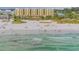 Aerial view of beachfront condo building and beach with people at 915 Seaside Dr # 312 Weeks 16-17, Sarasota, FL 34242