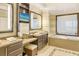 Elegant bathroom with double vanity, soaking tub, and TV at 915 Seaside Dr # 312 Weeks 16-17, Sarasota, FL 34242