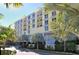 Exterior view of a yellow condo building with palm trees at 915 Seaside Dr # 312 Weeks 16-17, Sarasota, FL 34242