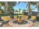 Another outdoor fire pit with comfortable seating and yellow pillows at 915 Seaside Dr # 312 Weeks 16-17, Sarasota, FL 34242
