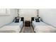 Guest bedroom with two twin beds and beach-themed decor at 1125 N Moonmist Ct # L5, Sarasota, FL 34242