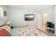 Large bedroom with king bed, flat-screen TV and home office area at 1125 N Moonmist Ct # L5, Sarasota, FL 34242