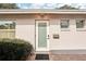 Front entrance of the house with a modern frosted glass door and brick walkway at 1125 N Moonmist Ct # L5, Sarasota, FL 34242