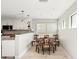 Eat-in kitchen featuring stainless steel appliances and a light wood dining set at 1125 N Moonmist Ct # L5, Sarasota, FL 34242