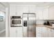 Modern kitchen with stainless steel appliances and white cabinetry at 1125 N Moonmist Ct # L5, Sarasota, FL 34242