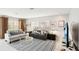 Open living room with neutral color palette, comfortable seating, and large TV at 1125 N Moonmist Ct # L5, Sarasota, FL 34242