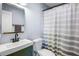 Clean bathroom with a shower/tub combo and green vanity at 13630 County Road 675, Parrish, FL 34219