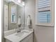 Small bathroom with vanity, mirror, and window shutters at 17022 Cresswind Ter, Lakewood Ranch, FL 34211