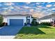 Single-story home with gray garage door and landscaped lawn at 17022 Cresswind Ter, Lakewood Ranch, FL 34211