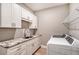 Laundry room with white cabinets, granite countertop, and a washer and dryer at 17022 Cresswind Ter, Lakewood Ranch, FL 34211