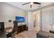 Home office with desk, chair, and large TV at 17022 Cresswind Ter, Lakewood Ranch, FL 34211